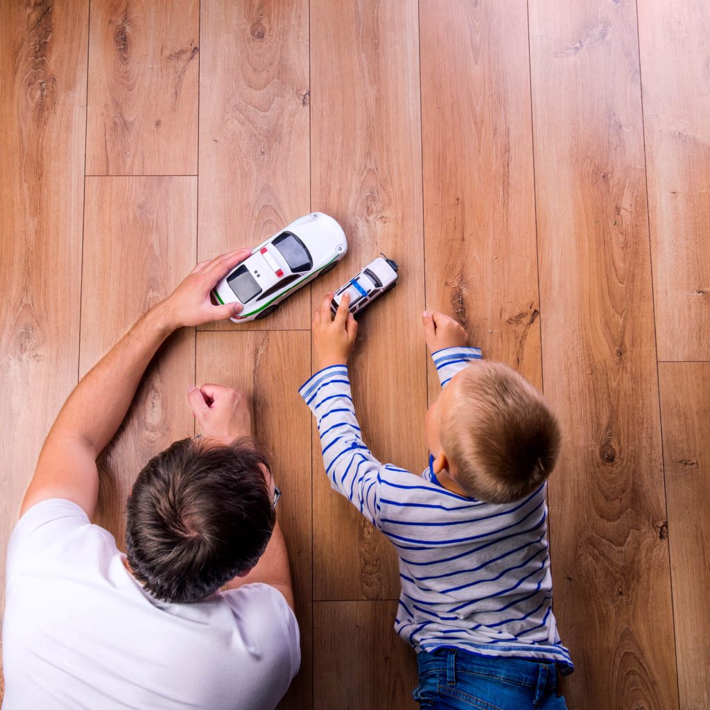 Father with kid playing with toycar | Tom January Floors