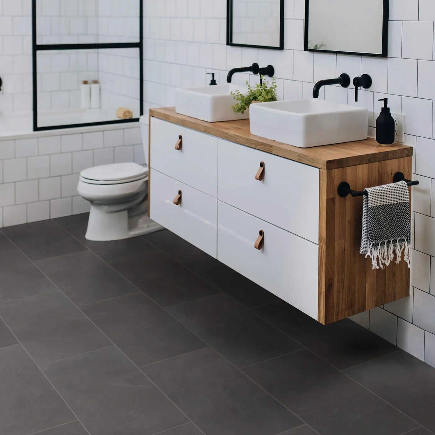 Callisto-12x24-430TS-Ember-00900-RM-V Shaw Floors Ember dark gray rectangular tile in a modern bathroom | Tom January Floors